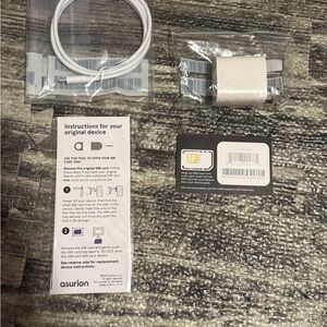 iPhone SE extra charger, SIM card and ejector tool.